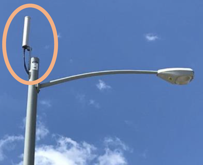 Photo of a street light pull with a small cell wireless facility placed on top