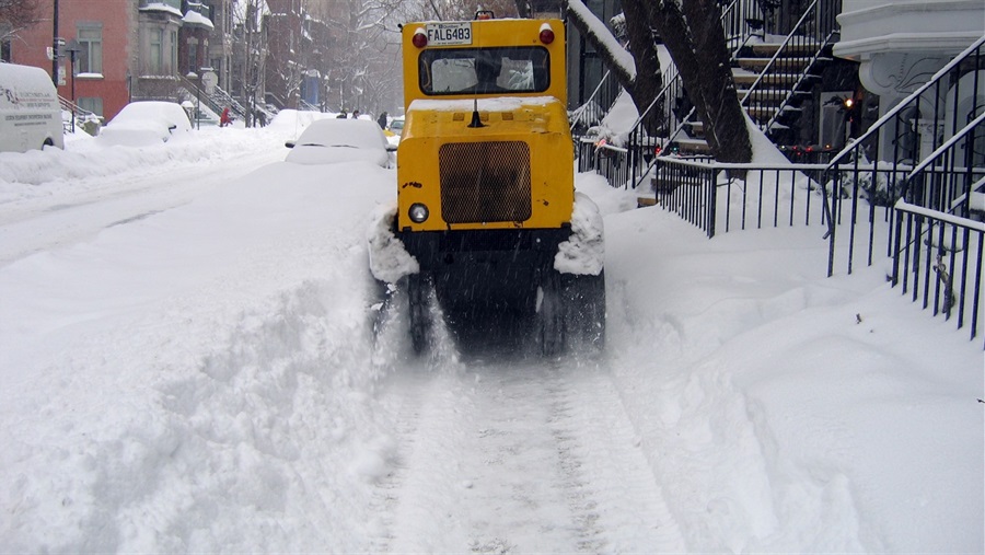 JPG image of plow clearing a sidewalk of snow - Photo Credit to Simon Law https://www.flickr.com/photos/sfllaw/74490693